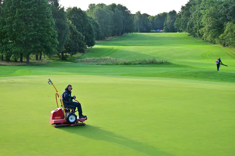 The sixth green getting a morning roll.