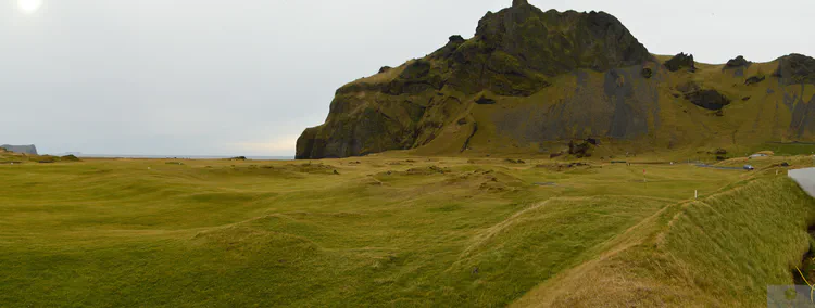 view from the maintenance building at Westman Islands GC: Westman Islands GC sits on an amazing piece of land, and the course plays through natural grassland with a few outcrops of volcanic rock. A few holes out of the frame to the left play through lava along the ocean. At far right is the site of the town festival, held each summer and one of the most popular festivals in Iceland. The grass-roofed stage is seen, with a natural amphitheater behind it.