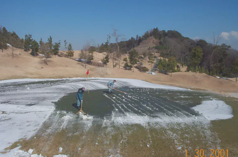 Pushing snow off the first green at Habu CC.