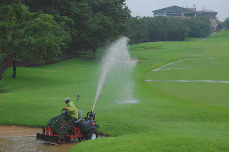 Pumping water from a bunker on the 1st hole at Keya GC during the 2nd round of the 2014 KBC Augusta tournament.