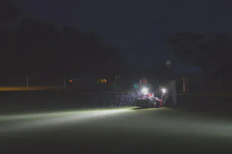 Mowing a practice green on a rainy morning at Keya GC.