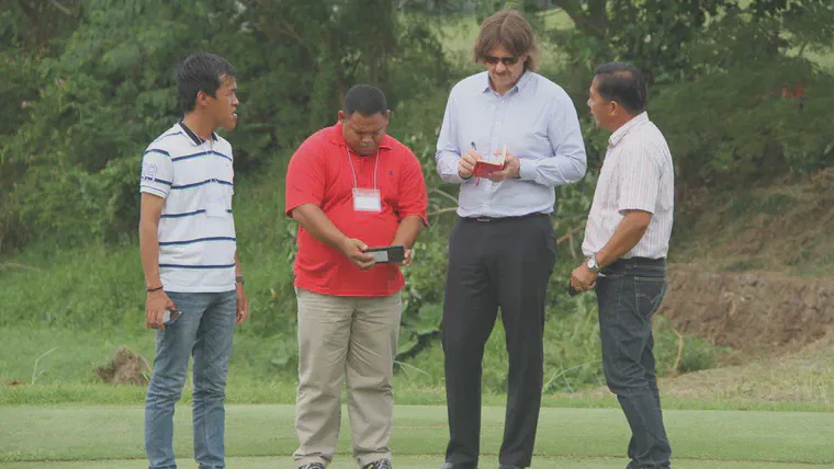 Speaking with delegates while checking the demonstration green at the Aoki Course at Eagle Ridge GC.
