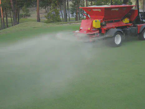 Application of granular silicon dioxide to a creeping bentgrass putting green in Japan.