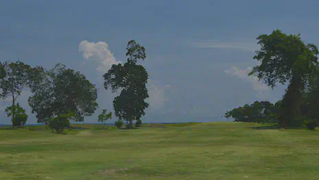 Approach to the par 5 16th at Tublamu Navy Golf Course with the Andaman Sea just over the green